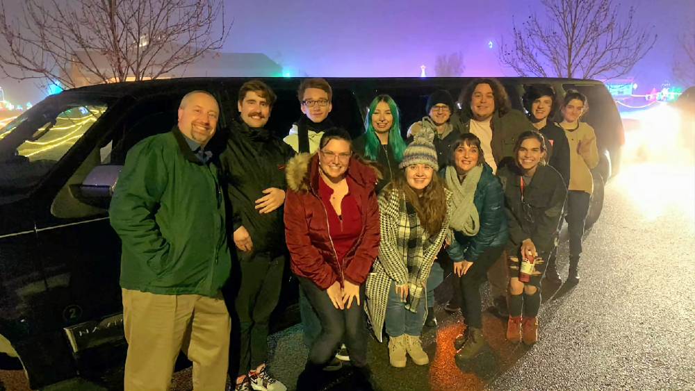 people in front of escape entertainment vehicle at night